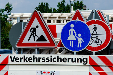 A worker's truck with roadsigns at a road construction site