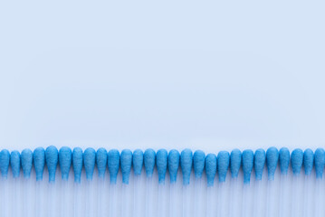 A row of cotton buds on a white background.
