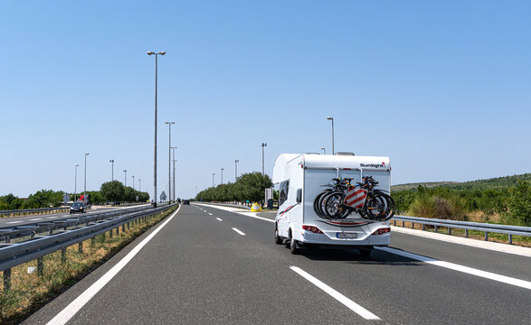 Zadar, Croatia - July 29, 2021: Tourists car with bicycles on the motorway in the city of Zadar, Croatia.