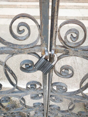 Vintage metal black lock on the gates, ornamental lattice 