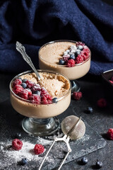 Ryazhenka mousse in glass bowls decorated with fresh berries