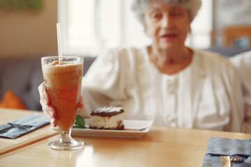 Beautiful old couple sitting in a cafe