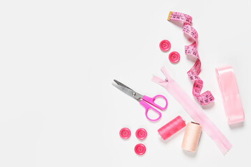 Sewing items from above. Flat lay composition with sewing accessories on light color background. Items for sewing, Sewing clothes, measuring tape, tailoring scissors, threads, buttons and needles