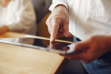 Elegant old man in a cafe using a laptop