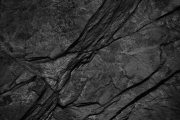 Black white rock texture. Close-up. Dark stone background with copy space for design.