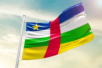 Central African Republic national flag waving in beautiful clouds.