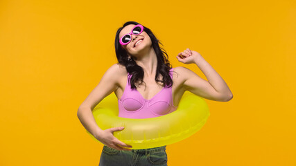 Happy woman in swim ring isolated on yellow.