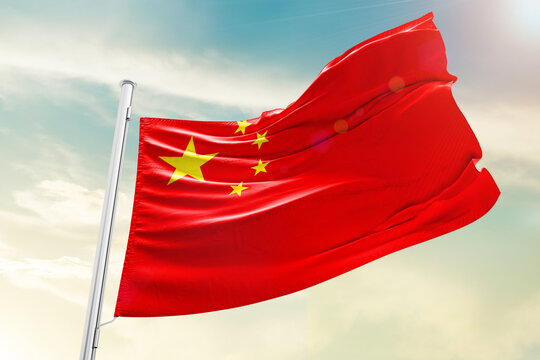 China national flag waving in beautiful clouds.