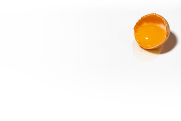 half shell with broken chicken egg on white background