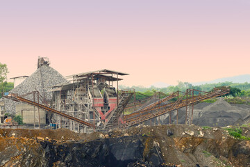 Idustrial background with working gravel crusher ,stone crusher in a quarry. mining industry,lanscape.