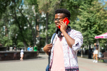 african tourist in sun goggles with mobile phone 