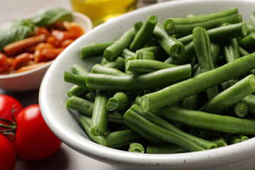 Fresh green beans and other ingredients for salad on table, closeup