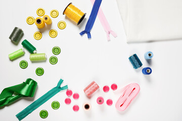 Sewing items from above. Flat lay composition with sewing accessories on light color background. Items for sewing, Sewing clothes, measuring tape, tailoring scissors, threads, buttons and needles
