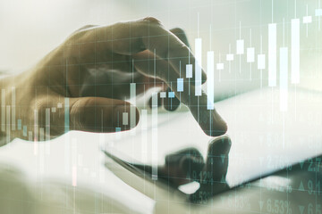 Abstract creative financial graph with finger clicks on a digital tablet on background, financial...