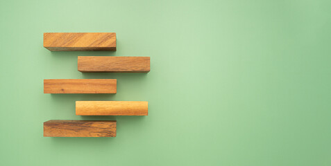 Top view of wooden blocks isolated on a green background