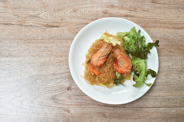 fried glass noodles with shrimp and cabbage with egg on plate