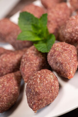 Traditional kebbe and pita bread on big round plate in lebanese restaurant. High quality photo