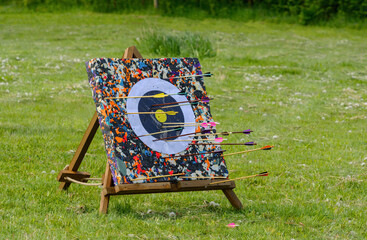 Target with arrows. Quiver with arrows for a bow. Box with arrows for a sport bow 
