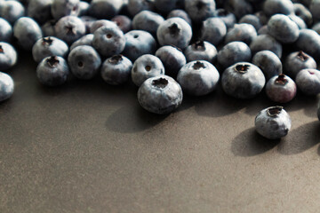 Blueberries ripe and tasty on a black background. Berries close up, Texture blueberry.