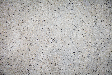 Cement mixed small gravel stone wall or floor texture background,The Dust Texture. Abstract dense splash texture. Random pebble gravel oval elements seamless pattern.