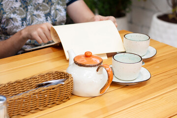 A man in a restaurant reads the menu