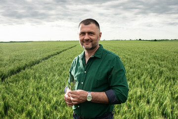 Portrait of farmer standing in wheat field.