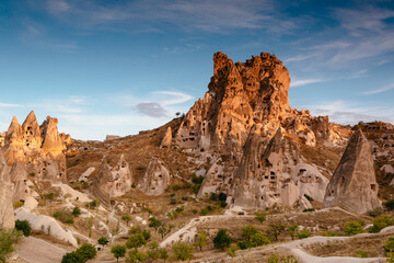 Amazing view of Uchisar Castle at suset.  The high castle mountain, which is visible over a wide...