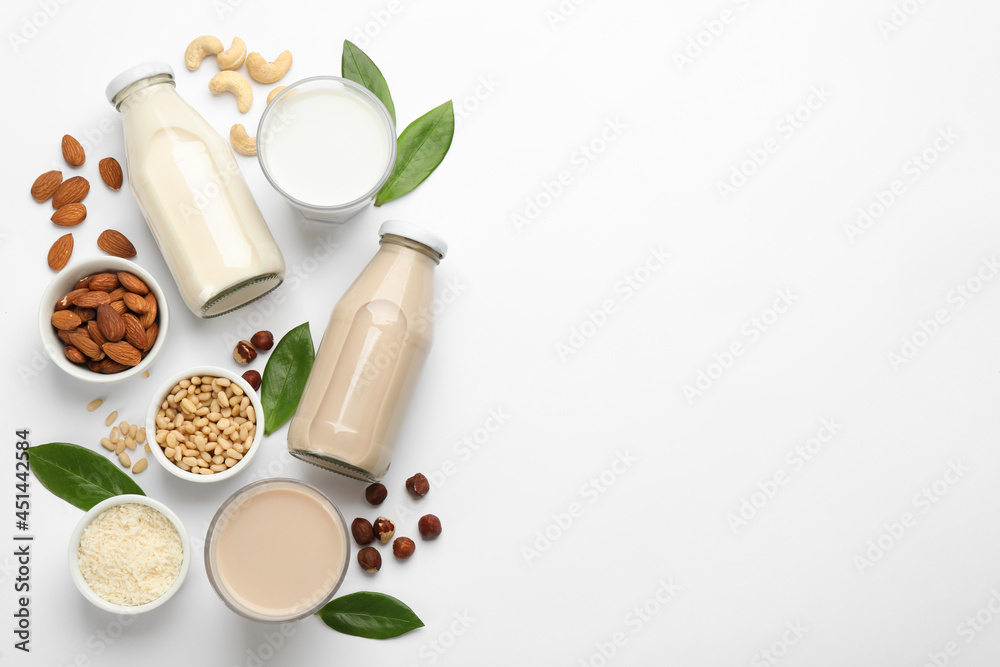 Poster Different vegan milks and ingredients on white background, flat lay. Space for text