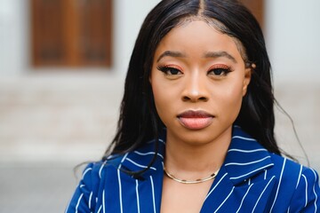 happy young african american businesswoman in city