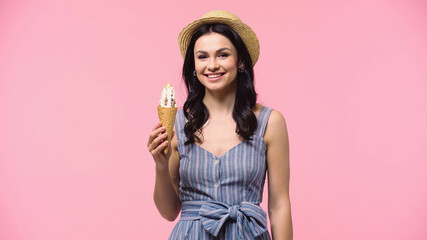 Pretty woman holding ice cream in waffle cone isolated on pink.