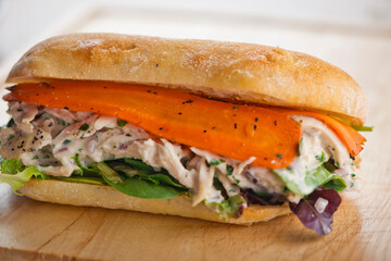 Chicken sandwiches. Served on toasted whole grain bread with melted Swiss cheese, mayonnaise and seasoned salt and pepper.  Classic American restaurant or diner lunch or brunch sandwich favorite.