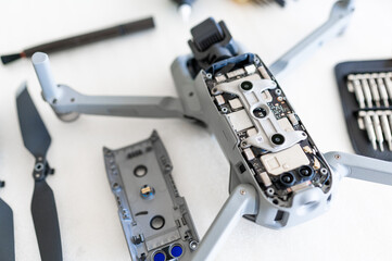 Fototapeta na wymiar Close-up disassembled drone on white table