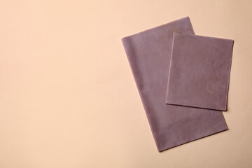 Reusable beeswax food wraps on beige background, top view. Space for text