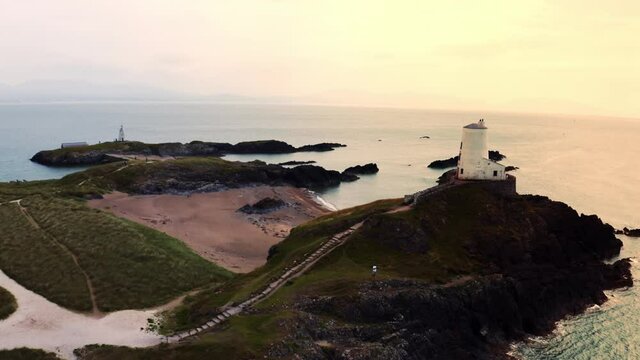 Aerial view of Twr Mawr lighthouse meaning great tower in Welsh on Ynys Llanddwyn on Anglesey Wales marks the western entrance to the Menai Strait.