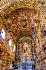 Fototapeta na wymiar Interior and altar of a brazilian historic ancient church from the 18th century in baroque architecture with details of the walls in gold leaf in the city Rio de Janeiro, Brazil