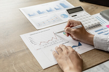Financial scholars are looking at numbers on financial documents to verify the accuracy of company financial data, financial status documents line and pie charts. Finance concept.