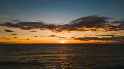 Fototapeta premium Dramatic yellow sundown and amazing view sea.Beautiful smooth waves and beautiful cloud in sky.