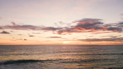 Naklejka na ściany i meble Beautiful sunset over the beach.tropical sundown over the sea cloud and waves golden beach.