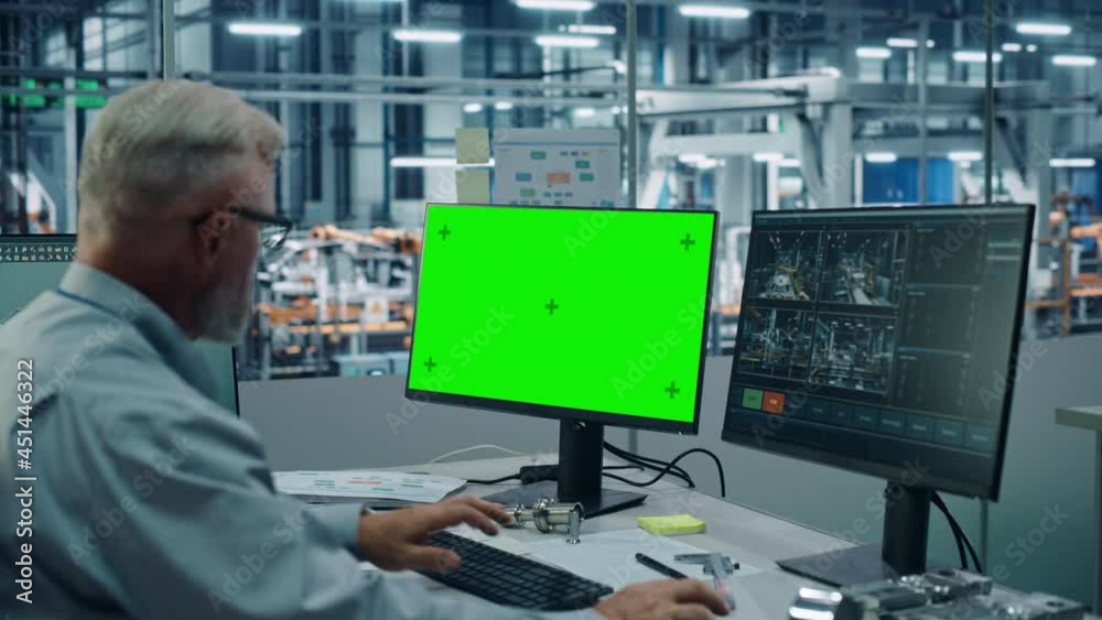 Poster car factory monitoring office: male chief automotive engineer sitting at the desk working on green s