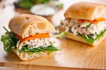 Chicken sandwiches. Served on toasted whole grain bread with melted Swiss cheese, mayonnaise and seasoned salt and pepper.  Classic American restaurant or diner lunch or brunch sandwich favorite.