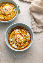 Turkish Eggs Dish Cilbır in Small Blue Bowl