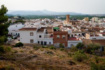 Fototapeta na wymiar Aerial view on the Spanish old town with the church tower of 'San Roque' in the center, Oliva, Spain