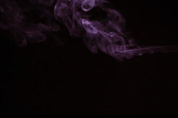 Purple smoke on black background.