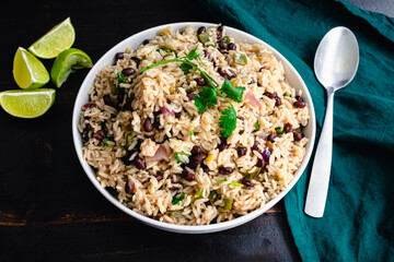 Cilantro Lime Rice with Black Beans in a Serving Bowl: A bowl of beans and rice garnished with...