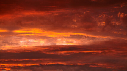 Fototapeta premium Red sunset sky with dramatic clouds