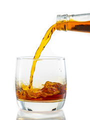 pouring whiskey into a transparent glass on a white background