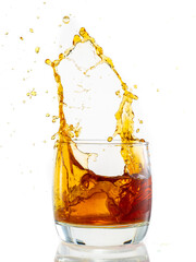 splash from falling ice glass with whiskey on white background