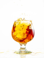 splash and flow in a round brandy glass