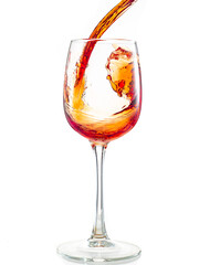 splash of red wine in glass on white background