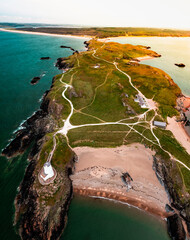 Aerial view of Twr Mawr lighthouse meaning great tower in Welsh on Ynys Llanddwyn on Anglesey Wales marks the western entrance to the Menai Strait.